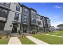 Three-story townhome with a well-maintained lawn and landscaped front yard at 205 Somerset Acres Dr, Summerville, SC 29486