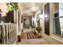 Inviting front porch with decorative lanterns, plants and a neutral welcome mat creating a cozy entrance at 205 Towhee Dr, Summerville, SC 29485