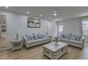 Cozy living room features comfortable sofas, decorative pillows, hardwood floors, and a decorative center table at 205 Towhee Dr, Summerville, SC 29485