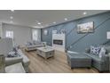 Stylish living room with a fireplace, modern furniture, hardwood floors, and a decorative accent wall at 205 Towhee Dr, Summerville, SC 29485