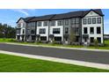 New townhomes boast modern design with gray and white exteriors, and professional landscaping at 209 Somerset Acres Dr, Summerville, SC 29486