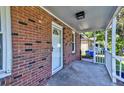 Welcoming front porch featuring brick accents and a white picket railing at 2657 Oregon Ave, North Charleston, SC 29405
