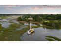 An aerial view showcasing a house with a private dock and waterfront access amid lush surroundings at 2834 Parkers Landing Rd, Mount Pleasant, SC 29466