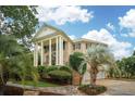 A luxurious home features a columned entrance, a brick facade, and mature palm trees at 2834 Parkers Landing Rd, Mount Pleasant, SC 29466