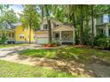 Charming home featuring a lovely front porch, well-maintained lawn, and an attached garage at 3005 Macbeth Creek Dr, Charleston, SC 29414