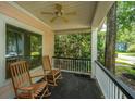 Relax on this charming front porch with rocking chairs and a ceiling fan at 3005 Macbeth Creek Dr, Charleston, SC 29414