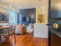 Open-concept living room and kitchen with hardwood floors and stylish furnishings at 4 Beaufain St # 207, Charleston, SC 29401