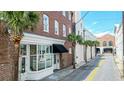 A view of the building's street with palm trees and sidewalk at 4 Beaufain St # 207, Charleston, SC 29401