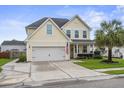 Charming two-story home featuring a well-manicured lawn, two-car garage, and a classic blue front door at 411 Topcrest Ln, Moncks Corner, SC 29461