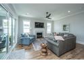 Bright living room with hardwood floors, fireplace, ceiling fan, and comfortable seating at 436 Ripple Park Dr, Summerville, SC 29486