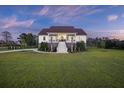 Beautiful two-story home with a welcoming front porch and lush landscaping at 4808 Wilson Rd, Meggett, SC 29449