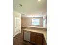 View of the kitchen with a bar and cabinets and leading to a dining area with natural light at 4816 Cane Pole Ln, Summerville, SC 29485