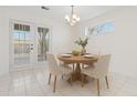 Bright dining area with french doors, a modern light fixture, and seating for four at 4850 Habersham Ln, Summerville, SC 29485