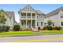 Attractive two-story home with a double porch, showcasing classic architectural design and landscaping at 5242 E Dolphin St, North Charleston, SC 29405