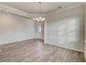 Elegant dining room with modern chandelier and wood floors at 541 Verdi Dr, Summerville, SC 29486