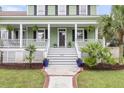 Charming two-story home with a welcoming porch, stairs leading to the front door, and well-maintained landscaping at 591 Two Mile Run, Johns Island, SC 29455