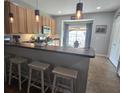 Well-lit kitchen featuring a breakfast bar with stools, pendant lighting, and stainless steel appliances at 605 Grassy Hill Rd, Summerville, SC 29483