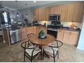 Spacious kitchen with wood cabinets, stainless steel appliances, and a round dining table with chairs at 605 Grassy Hill Rd, Summerville, SC 29483