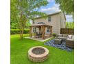 Spacious backyard with a gazebo, fire pit, and comfortable seating area at 708 Professor Dr, Ladson, SC 29456