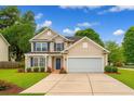 Charming two-story home with a well-manicured lawn and blue shutters at 708 Professor Dr, Ladson, SC 29456