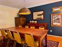 Dining room with a large wooden table, eight chairs, a decorative light fixture, and a colorful rug at 8 Brisbane Dr, Charleston, SC 29407