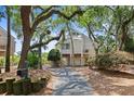Attractive coastal home with a private driveway, set amidst mature trees and lush landscaping at 811 Treeloft Trce, Seabrook Island, SC 29455
