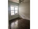 A well-lit bedroom features hardwood floors and a ceiling fan at 8930 Selah St, North Charleston, SC 29406