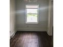 An empty room features hardwood floors and a large window at 8930 Selah St, North Charleston, SC 29406