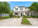 Inviting two-story home with a covered front porch, tidy landscaping, and a welcoming entrance at 9049 Parlor Dr, Ladson, SC 29456