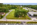 A bird's-eye view of the commercial property with mature trees and a view of the neighborhood beyond at 9612 Hoot Owl Ave, Ladson, SC 29456