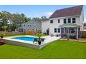 Relaxing backyard with a pristine pool, screened porch, and ample lounge space at 9713 Cutleaf Dr, Ladson, SC 29456