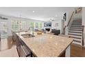 Open-concept kitchen with granite countertops, stainless appliances, and seamless flow to living spaces at 9713 Cutleaf Dr, Ladson, SC 29456