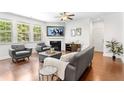 Cozy living room featuring a fireplace, hardwood floors, and comfortable seating at 9713 Cutleaf Dr, Ladson, SC 29456