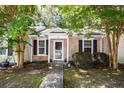 Charming single-story home with brick facade, black shutters, and inviting landscaping at 102 Sandy Hook Ct, Summerville, SC 29486
