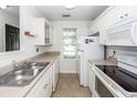 Functional kitchen with white appliances, tile floor, and stainless steel sink at 102 Sandy Hook Ct, Summerville, SC 29486