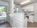 Bright kitchen with white cabinets and appliances, plus convenient eat-in bar at 102 Sandy Hook Ct, Summerville, SC 29486