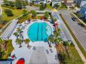 Community pool with lap lanes, sun loungers, pergolas and umbrellas and palm trees at 107 Cotton Blossom Way, Summerville, SC 29485