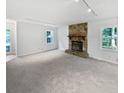 Spacious living room featuring stone fireplace and light-filled windows at 109 Evance Ct, Summerville, SC 29485