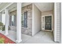 Welcoming front porch with brick accents leading to a stylish black front door at 112 Mayfield Dr, Goose Creek, SC 29445