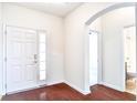 Bright foyer featuring hardwood floors, white trim, and arched doorway leading to a bathroom at 112 Mayfield Dr, Goose Creek, SC 29445