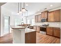 Modern kitchen with granite countertops, stainless steel appliances, and wood-look floors at 112 Mayfield Dr, Goose Creek, SC 29445
