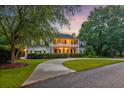 Charming two-story home with inviting porch and manicured lawn, perfect for Gathering living at 115 Old Postern Rd, Summerville, SC 29483
