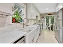 Bright kitchen with white cabinets, marble countertops, and stainless steel appliances at 1199 Parkway Drive, Mount Pleasant, SC 29464