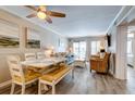 Comfortable living space with a dining table, cozy furniture, and a sliding door to the balcony at 1400 Ocean Blvd # 106B, Isle of Palms, SC 29451