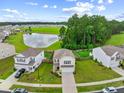 Expansive aerial view showing the home's location within a Gathering-friendly community with pond and green spaces at 141 Sweet Cherry Ln, Summerville, SC 29486