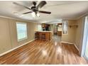 Inviting living area with hardwood floors, bar-style seating, open to the kitchen, and a bright window at 149 Old Red Hill Rd, Ridgeville, SC 29472