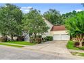 Well-manicured lawn and landscaping complement this home with a two-car garage at 1664 William Hapton Way, Mount Pleasant, SC 29466