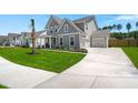 Charming gray home with an attached two-car garage and long driveway at 1950 Parish House Cir, Johns Island, SC 29455