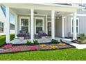 Charming front porch with rocking chairs, decorative plants, and ambient lighting at 1950 Parish House Cir, Johns Island, SC 29455