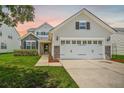Attractive home with mixed siding, stone accents, a neat lawn, and a practical two-car garage at 199 Decatur Dr, Summerville, SC 29486